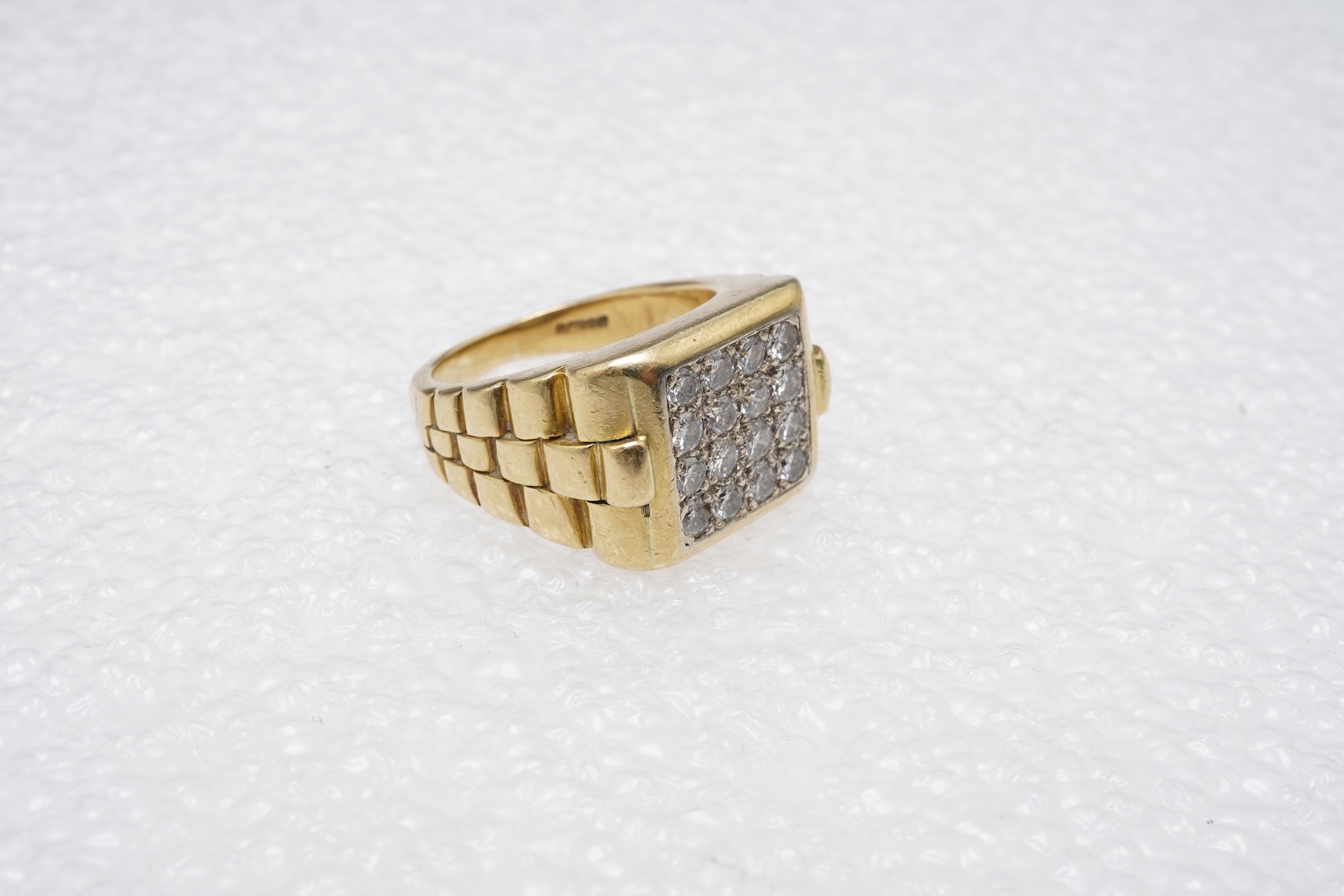 A gold and diamond signet ring